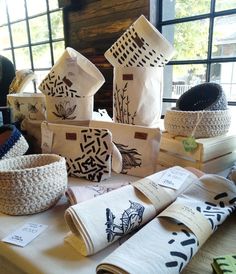 many baskets are stacked on top of each other in front of a window with windows