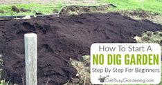 a pile of dirt sitting in the middle of a field next to a wooden post