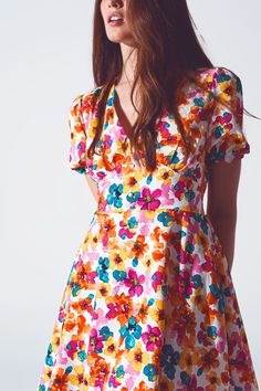 Delve into the boho chic style with our Short Dress with Cinched Waist in Multicolor Floral Print. The dress is constructed from 100% Polyester, assuring a lightweight feel and longevity. The model, standing at 5'8'' with measurements of 33-24-35, wears a size S and the dress runs true to size. Its regular fit coupled with an elasticated back offers a figure-hugging cut, accentuating your curves perfectly. The mini length and the vivacious floral print make this dress a standout for casual and f Ditsy Floral Print V-neck Dress For Garden Party, Multicolor V-neck Floral Dress With Vibrant Print, Colorful Floral Print V-neck Dress, Spring Floral V-neck Dress With Vibrant Print, Multicolor Print V-neck Summer Dress, Patterned Floral Print V-neck Maxi Dress, Vibrant Floral Print V-neck Mini Dress, Printed Floral Mini Dress For Garden Party, Flowy V-neck Floral Dress