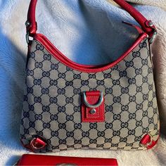 Authentic Gucci Abbey Shoulder Bag With Canvas Gg In Blue And Red Leather Trim. Excellent Condition. All Leather (Trim And Handle) Are In Tact. Canvas Is Clean And In Great Condition. No Stains Or Rips. Interior Is Clean With One Small Pocket Inside. Measures 11.5 X 10 X 2. Wallet Not Included! Comes With A Silk Dustbag. (Not Gucci). Red Gucci Shoulder Bag With Detachable Handle, Gucci Red Bag With Removable Pouch, Gucci Red Shoulder Bag With Removable Pouch, Gucci Bags, Leather Trim, Gucci Bag, Leather Trims, Red Leather, Inside Pocket