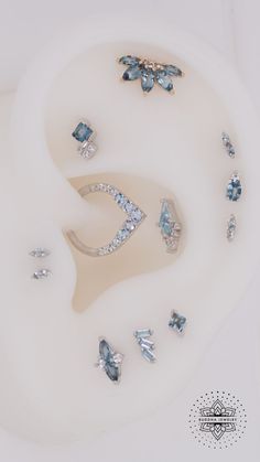 an assortment of diamond and blue topaz rings on a white surface with the words, diamonds