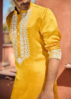 The mehrangarh kurta in mustard is a vibrant and stylish choice for Indian grooms, designed for haldi, mehndi, or sangeet ceremonies. Crafted from premium viscose cotton silk, this kurta provides a smooth and comfortable feel, ideal for festive occasions. Paired with an ivory salwar, this kurta ensemble offers a balanced and sophisticated look.The mehrangarh kurta is an excellent choice for grooms seeking a traditional yet contemporary outfit. Pair with traditional or modern footwear for a polished appearance at pre-wedding events. Indian Groom, Bespoke Tailoring, Contemporary Outfits, Sophisticated Look, Cotton Silk, Pre Wedding, Wedding Events, Mustard, Festival