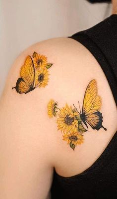 two butterflies on the back of a woman's shoulder, with sunflowers