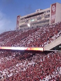 a large stadium filled with lots of people sitting on the bleachers and watching something