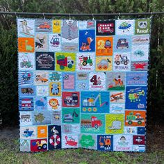 a quilt made to look like it has cars and trucks on it, with trees in the background