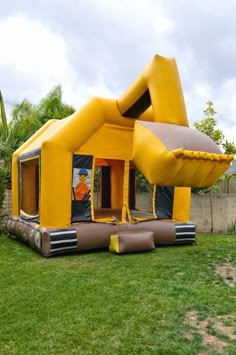 an inflatable bounce house is set up on the lawn