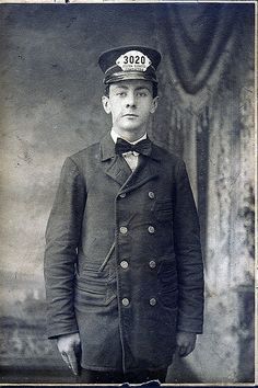 an old black and white photo of a man in uniform