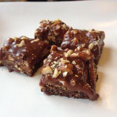 three pieces of chocolate brownie with nuts on top