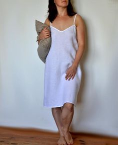 Linen summer nightgown.Lovely and simple night dress for women with frill.Very comfortable and soft. Linen fabric ensures comfort: cold for hot summer nights and warmth for cold winters.Fabric: 100% linen (medium weight linen).Color in the picture: whiteProduce time is about 1-5 days.The model is 168 cm /5ft5" high (size S) and the model is wearing the top in size S.Length approx. 37.4" (95cm)SIZING:XS (US 2, UK 6)Bust: fits bust around 84 cm / 33"Waist: fits waist around 66 cm / 26"Hips: fits h Elegant Summer Dresses For Relaxation, Summer Home Dresses With Spaghetti Straps, White Spaghetti Strap Night Dress, White Summer Sleep Dress, Comfortable Summer Nightgown For Bedtime, White V-neck Slip Dress For Bedtime, Comfortable Summer Nightgown, White V-neck Night Dress, Summer V-neck Slip Dress For Bedtime