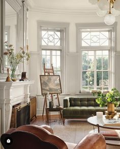 a living room filled with furniture and lots of windows