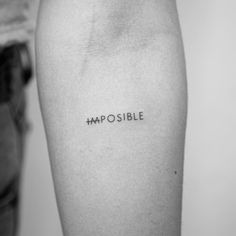 a person with a tattoo that says impossible