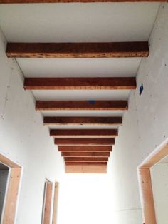 an empty room with unfinished wood beams on the ceiling