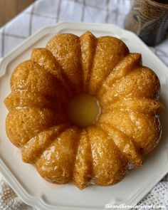 a bundt cake on a white plate with the words kentucky butter cake above it