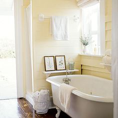 a white bath tub sitting next to a window