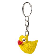 a yellow bird keychain with a red beak on it's head and eyes