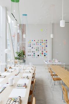 a long table in a large room with lots of tables and chairs next to it