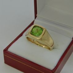 Gemstone: Peridot (from USA) Treatments: Untreated Specifications: 8x8mm, approx. 2.53 carats Color: As shown Clarity: Eye clean Cut: Cushion cut Weight: 16 grams. Ring size: 10, with all sizes available from 6.5 through 12 This is as fine and elegant a man's ring as you will ever find. The perfect blend of a fine gemstone matched up with a clean classic 14K yellow gold ring. Good solid weight, nicely distributed to give the ring an even weight so that it will not spin. There is nothing worse th Green Rectangular Signet Ring For Formal Occasions, Gia Certified Gold Gemstones For Formal Occasions, Green Gemstone Signet Ring For Formal Occasions, Formal Green Gemstone Signet Ring, Formal Rings With Polished Peridot, Formal Peridot Rings With Polished Finish, Gold Peridot Rings For Formal Occasions, Classic Gold Ring With Peridot, Green 14k Gold Hallmarked Signet Ring