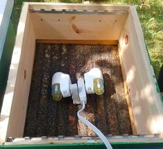 two electric plugs connected to the inside of a beehive