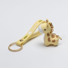 a giraffe shaped keychain is shown with a lanyard attached to it