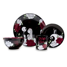 a black and red dinner set with roses on it