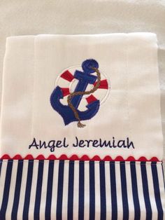 an embroidered towel with the name angel jeremiah written in blue and white stripes