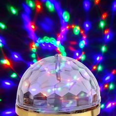 a close up of a light on top of a table with colorful lights in the background