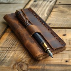 a pen is sitting in an old leather case