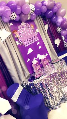 purple and white balloons are on display at a birthday party