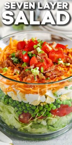 a layered salad in a glass bowl with the title overlay that reads seven layer salad