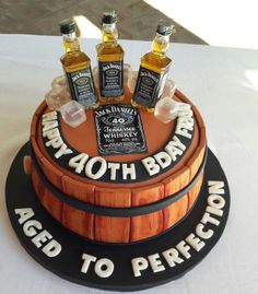 a birthday cake made to look like a barrel with whiskey bottles on the top and bottom