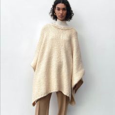 Ecru Cozy Sweater Poncho Cozy Oversized Off White Sweater, Cozy Oversized Off-white Sweater, Cream Oversized Knitted Outerwear, Oversized Cream Knitted Outerwear, Beige Knit Poncho One Size, Beige Knit Poncho, One-size Beige Knit Poncho, Cream Batwing Sleeve Sweater For Fall, Cozy One Size Cream Outerwear