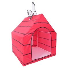 a red dog house with a cat on top