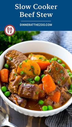 a white bowl filled with beef stew and carrots