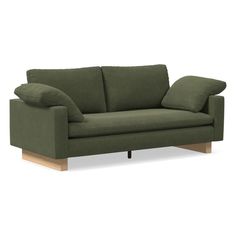 a green couch with two pillows on the back and one arm folded up in front