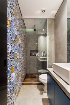 an image of a bathroom with tile on the walls