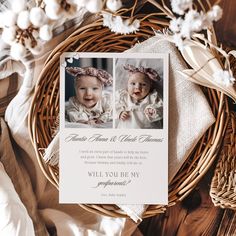 a baby's first birthday card on top of a wicker basket with cotton flowers