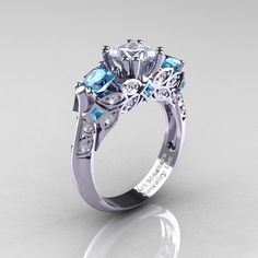 Exclusive, luxurious and rich, the new Classic 14K White Gold Three Stone Princess CZ Aquamarine Diamond Solitaire Engagement Ring R500-14KWGDAQCZ is sure to delight the most discriminating feminine taste.Includes: * 1 x over 5.0 grams TW (approx) of cast solid 14k white gold ring size 7 (sizable)* 24 x round 0.013 ~ 0.015 carat (approx 0.30 CTW) good quality VS-SI G-H white diamonds* 6 x princess 0.02 carat (approx 0.12 CTW) laboratory grown aquamarine accents * 2 x princess 0.6 carat laborator Art Masters Jewelry, Sapphire Solitaire Engagement Ring, Tool Organizers, Artificial Jewellery, Sapphire Solitaire, Earring Organizer, Box Diy, Blue Sapphire Diamond, Bridal Ring Sets