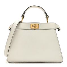 This is an authentic FENDI Shiny Nappa Petite Peekaboo I SEE U Satchel in White. This chic tote is finely crafted of white soft calfskin leather. This petite sized bag features a top leather handle, adjustable leather shoulder strap with gold hardware. This bag also features gold squared turn locks on either side that when released, opens to the inner panel of leather with a hanging patch pocket. Elegant Satchel With Dust Bag For Errands, Elegant Satchel With Gold-tone Hardware For Errands, Fendi Peekaboo Mini, Pokemon Fabric, Fendi Peekaboo Bag, Pop Stitch, Fendi Peekaboo, Phone Pouch, Fendi Bags