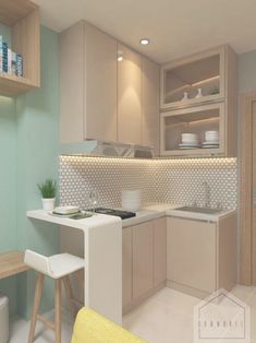 a small kitchen with light colored cabinets and white counter tops, along with a yellow chair