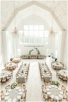 a large banquet hall with tables and chairs set up for an event or wedding reception