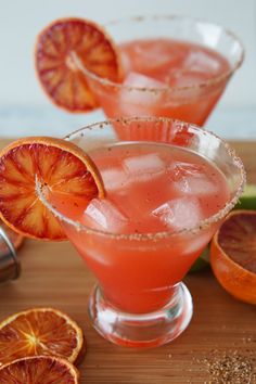 two glasses filled with blood orange margaritas and garnish