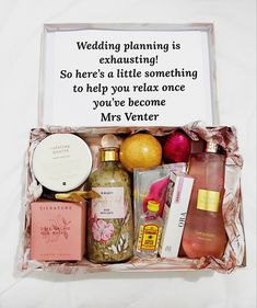 a box filled with lots of different types of personal care items and a sign that says, wedding planning is exhausting so here's a little something to help you relax once