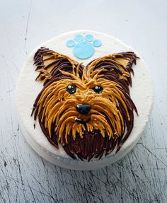 a decorated cake with a dog's face on it