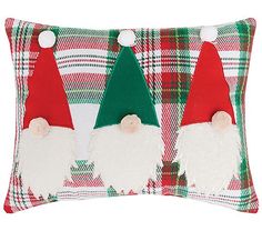 two christmas gnomes sitting on top of a plaid pillow with red, green and white flannel