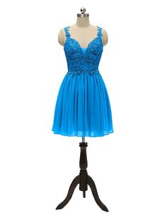 a blue dress on a mannequin stand