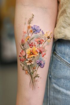 a woman's arm with flowers painted on it