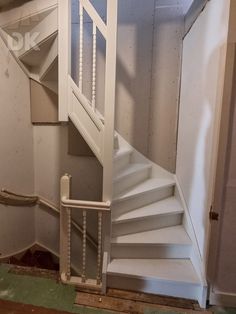 a white stair case in an unfinished room