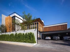 a modern house with an attached garage and car parking lot in front of the house