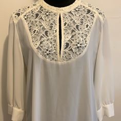 Lace Front & Back Yoke Blouse W Slightly Sheer Fabric Never Worn- Excellent Condition Long Sleeves Split Front- See Pic Top Button Closure In Back Comes W An Extra Button Back Slightly Longer Than Front Size L Armpit To Armpit-22 Inches Sleeve Length-18 1/2 Inches Length From Shoulders-26 Inches Off- White Color Beautiful Blouse! Ready For Any Occasion! Spring Brunch Blouse With Lace Collar, Spring Blouse With Lace Collar For Brunch, Spring Office Blouse With Lace Trim, Spring Workwear Blouse With Lace Trim, Spring Office Lace Top Blouse, Spring Office Lace Blouse, Spring Workwear Lace Top Blouse, Spring Lace Top Blouse For Work, White Lace Collar Blouse For Office