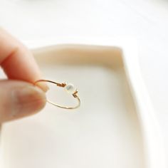 ✨ Mother Of Pearl Ring with 14K Gold Filled or Sterling Silver wire 🐚 Mother of pearl, also known as shell beads, is a stone of protection. It brings the gentle healing power of the sea. It is a stress-relieving stone; relaxing, soothing and calming to the emotions 💙 Tiny, dainty and cute Mother Of Pearl ring. You can wear it alone or stack them together. Make a cute pinky ring. • Gemstone Diameter: 4 mm • Ring Band: 0.8 mm • Handmade in your ring size with 14K gold-filled wire or Sterling Sil Pearl Stacking Ring, Mother Of Pearl Ring, Healing Power, Initial Jewelry, Pinky Ring, Minimalist Rings, Shell Beads, Pearl Ring, Silver Wire